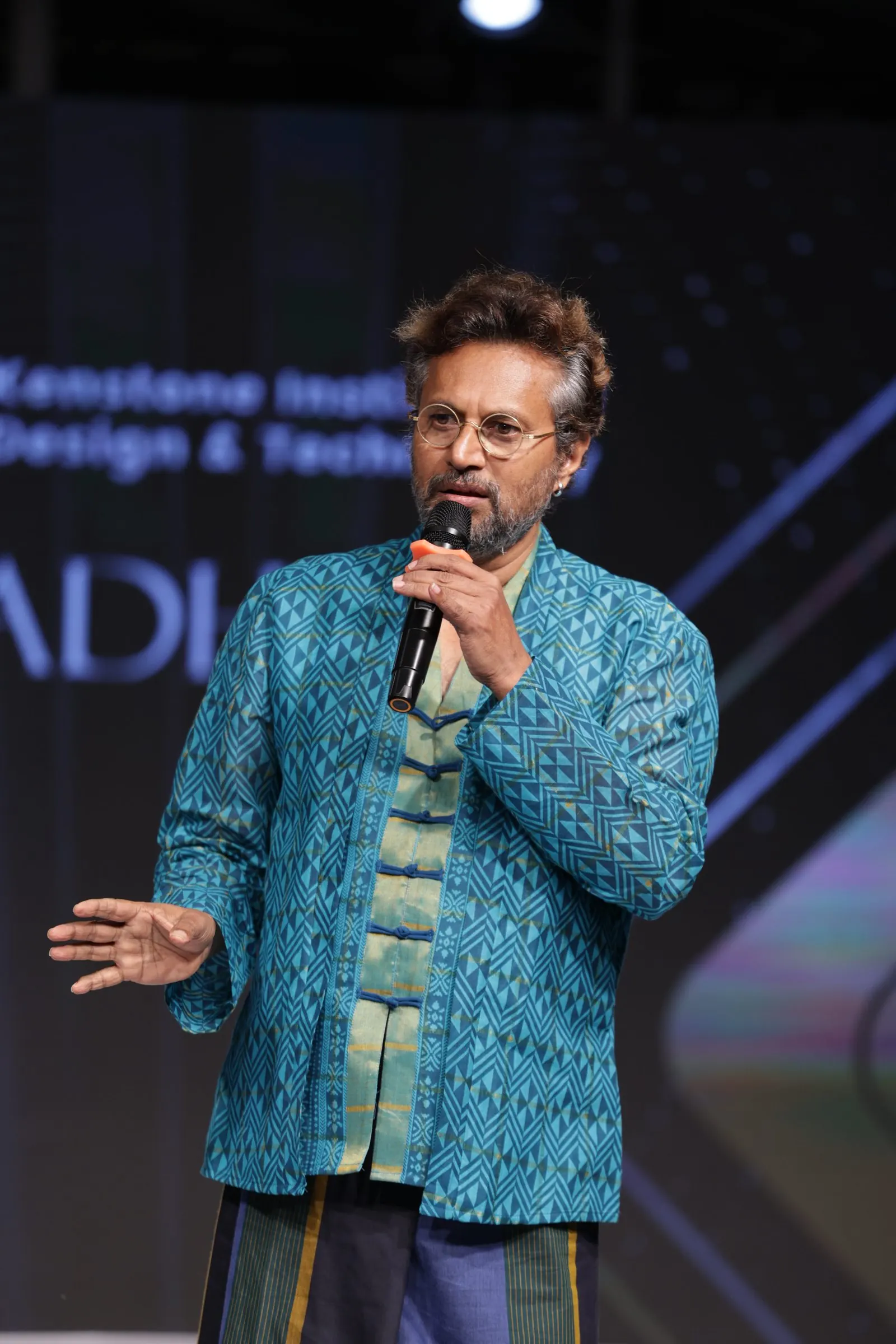 The chief guest speaking on stage at Sutradhar 2025